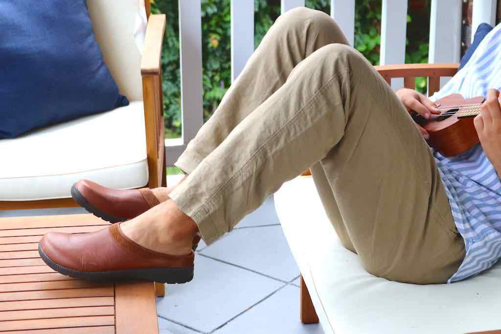 Comfy and leisurely Stegmann clogs on someone dressed for vacation.