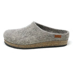 The Women's Eco Wool Clog is shown in grey felt with a cork latex footbed and small brown stitched side tag, viewed from the left. This sustainable wool footwear blends comfort and eco-friendly design.