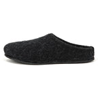 A Men's Alpine Comfort Wool Slipper in black, featuring fuzzy Merino wool, an open back, and an anatomically shaped cork insole, showcased on a plain white background.