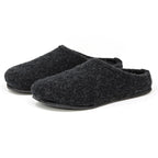 The Men's Alpine Comfort Wool Slippers, in dark gray with closed toes and black soles, showcasing an anatomically shaped cork insole, are placed side by side on a white background.
