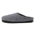 The Men's Alpine Comfort Wool Slipper features a soft gray merino wool upper, an anatomically shaped cork insole, and a black sole, shown from the side.