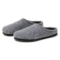 The Men's Alpine Comfort Wool Slipper features gray Merino wool uppers, black rubber soles, and anatomically shaped cork insoles for optimal comfort.