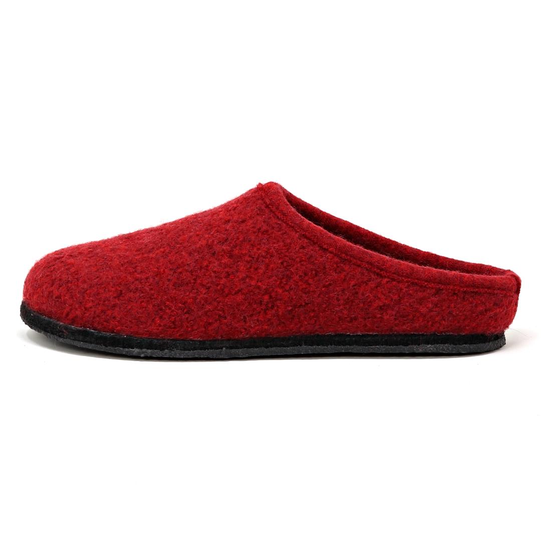 The Women's Alpine Comfort Wool Slipper is shown in a side view against a white background, featuring cozy red merino wool with a black sole and cork insole.