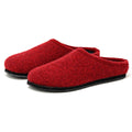 The Women's Alpine Comfort Wool Slipper is a red pair made from soft merino wool with durable black soles.