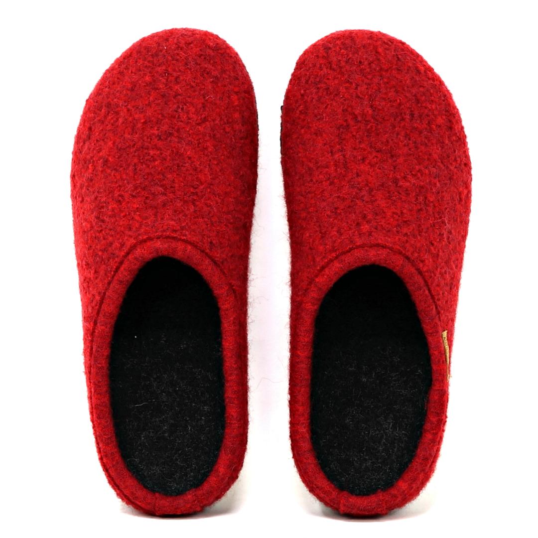 A pair of Women's Alpine Comfort Wool Slippers, featuring red felt wool exteriors, black interiors, and cork insoles, are displayed from above against a plain white background.