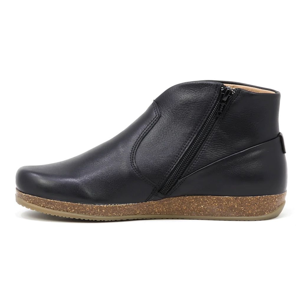 The Women's Leather Amalia Boot, shown in profile against a white background, features black leather, a side zipper, and a brown cork-textured sole.