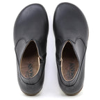 The Women's Leather Amalia Boot in black features a slip-on design with rounded toes, visible insoles, and side zippers, shown from a top-down view.