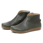 The Women's Leather Amalia Boot features olive green leather uppers, side zippers, and cork soles, displayed against a white background.