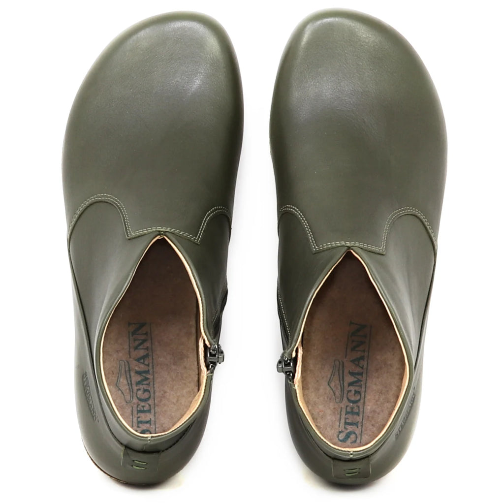 Top view of a pair of olive green Women's Leather Amalia Boot slip-ons with Stegmann branding visible on the insoles.