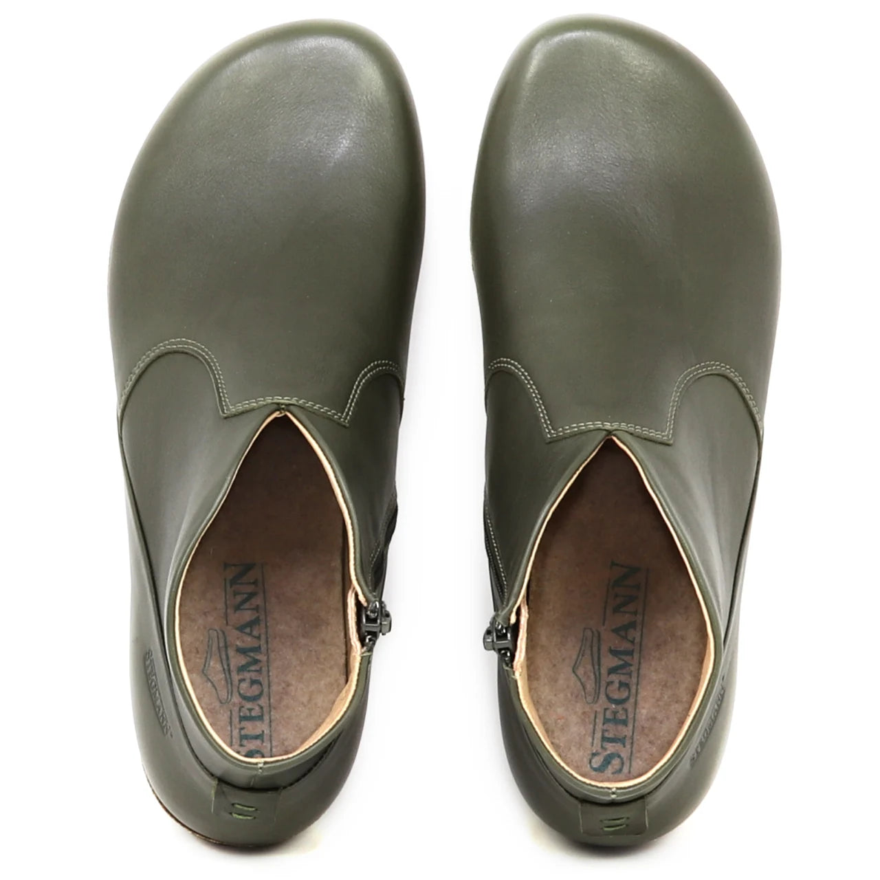 Top view of a pair of olive green Women's Leather Amalia Boot slip-ons with Stegmann branding visible on the insoles.