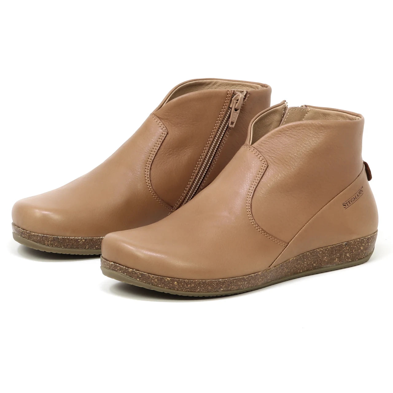 The Women's Leather Amalia Boot is shown in tan with side zippers and textured soles, displayed on a plain white background.