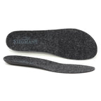 A pair of Women's Wool Contour Replacement Insoles w/Arch is displayed, with one insole shown from the top featuring the Stegmann logo and the other from the side to emphasize thickness, arch support, and durable wool felt material. These versatile inserts are designed to provide comfort and lasting wear every day.