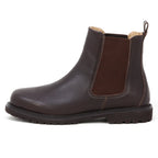 The Women’s Brenner Chelsea Boot is a brown, ultra-light waterproof Chelsea boot made from premium Portuguese leather, featuring an elastic side panel, a pull tab at the back, and a black rubber sole. It is displayed in profile on a white background.