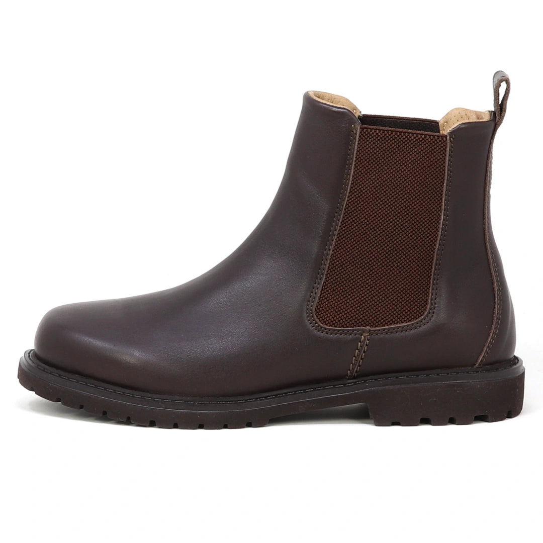 The Women’s Brenner Chelsea Boot is a brown, ultra-light waterproof Chelsea boot made from premium Portuguese leather, featuring an elastic side panel, a pull tab at the back, and a black rubber sole. It is displayed in profile on a white background.