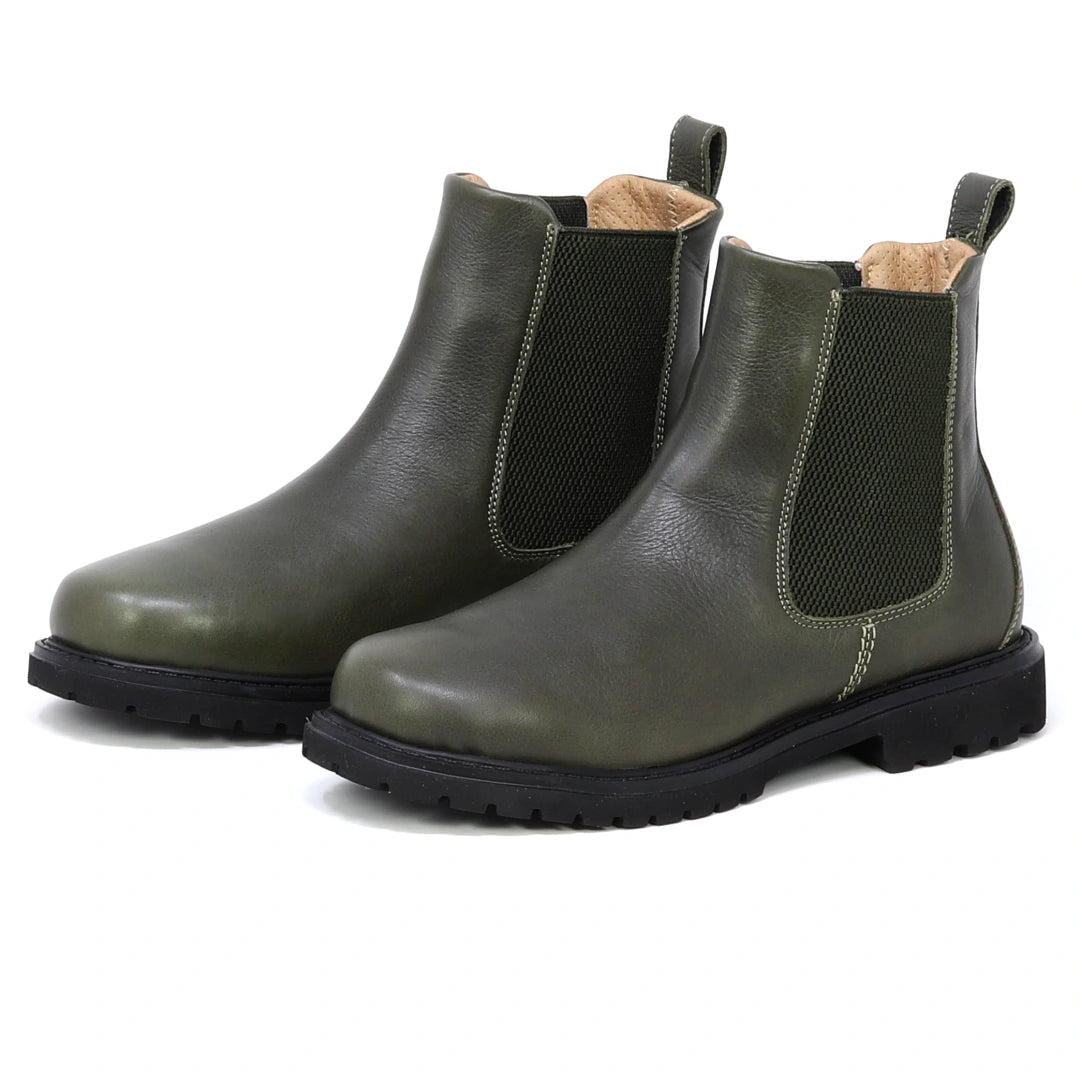 A pair of Women’s Brenner Chelsea Boots in olive green, crafted from premium Portuguese leather with black soles, ultra-light construction, elastic side panels, and back pull tabs, showcased on a white background.