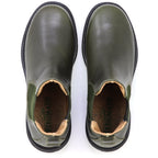 A pair of olive green Women’s Brenner Chelsea Boots with black soles, viewed from above. Crafted from premium Portuguese leather, the insoles are branded with the name “STEGMANN.”.