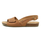 The Women's Clara Slingback Sandal is brown leather with an open toe, ankle strap, adjustable buckle, cushioned footbed for comfort, and a cork sole. It is displayed on a white background.