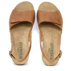 The Women's Clara Slingback Sandal features brown leather with flat soles, an open-toe design, and an adjustable buckle strap. Its Stegmann cushioned footbed ensures enhanced comfort, ideal for all-day wear.