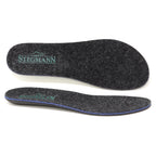 Two dark gray Women’s Wool Contour Plus+ Replacement Insoles w/Arch, featuring “Stegmann” and a shoe logo printed in green on the heel area, are shown from both top and side views. These insoles are designed with arch support for enhanced comfort throughout your day.
