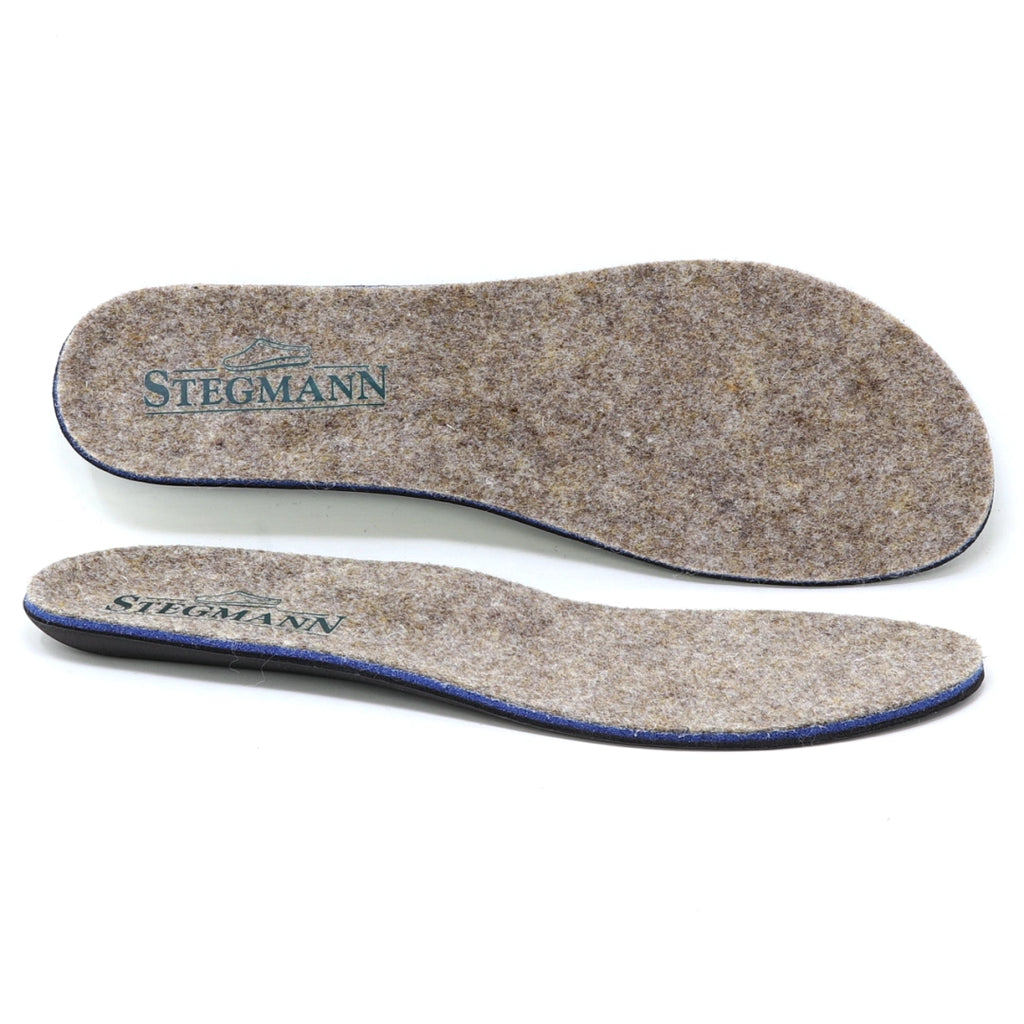 Two Women’s Wool Contour Plus+ Replacement Insoles w/Arch in gray felt, each featuring “Stegmann” branding, are displayed from top and side views against a white background. Crafted for superior arch support, these insoles offer enhanced comfort for everyday wear.