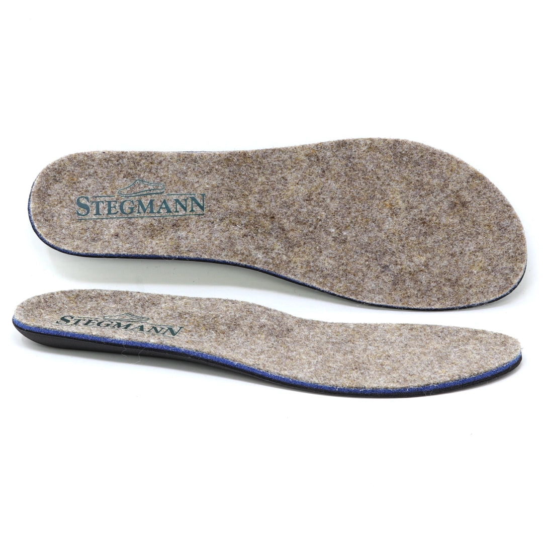 Two Women’s Wool Contour Plus+ Replacement Insoles w/Arch in gray felt, each featuring “Stegmann” branding, are displayed from top and side views against a white background. Crafted for superior arch support, these insoles offer enhanced comfort for everyday wear.