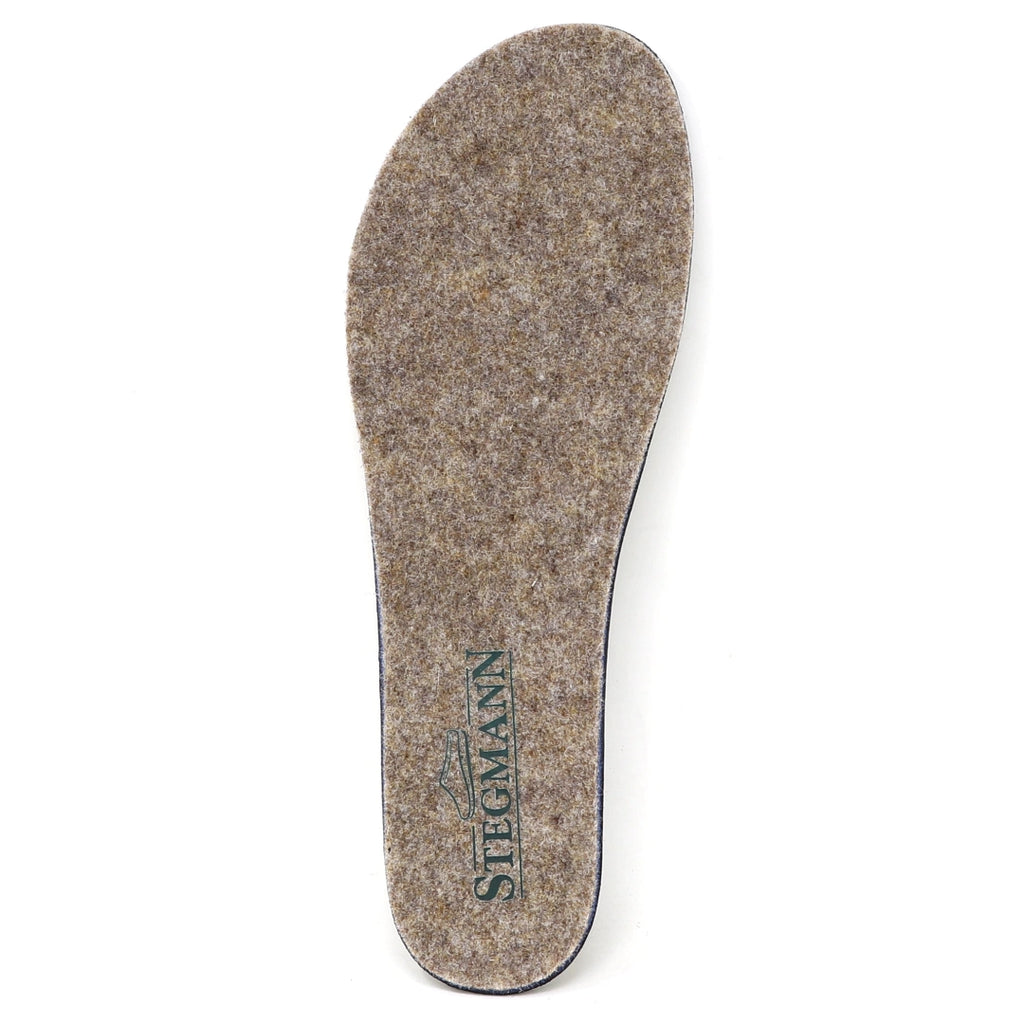 A single Women’s Wool Contour Plus+ Replacement Insole w/Arch in gray felt, featuring the word “Stegmann” and a green shoe logo printed near the heel, designed to offer enhanced arch support for lasting comfort.