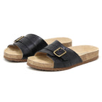 The Women's Ella Slide Sandal features black slip-on design with adjustable leather straps and contoured cork footbeds, shown on a white background.