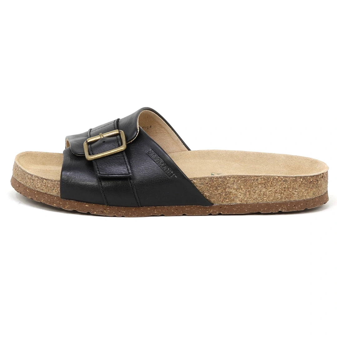 The Women's Ella Slide Sandal features black leather straps, a gold buckle, and a contoured cork footbed, shown in profile on a white background—reminiscent of the signature Birkenstock Gizeh style.