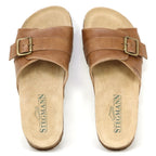 The Women's Ella Slide Sandal features tan leather, adjustable buckle straps, a contoured cork footbed, and "Stegmann" branding on the footbeds.