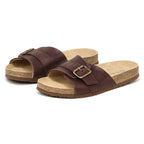 The Women's Ella Slide Sandal, shown on a white background, features a brown slip-on design with adjustable leather straps and a contoured cork footbed.