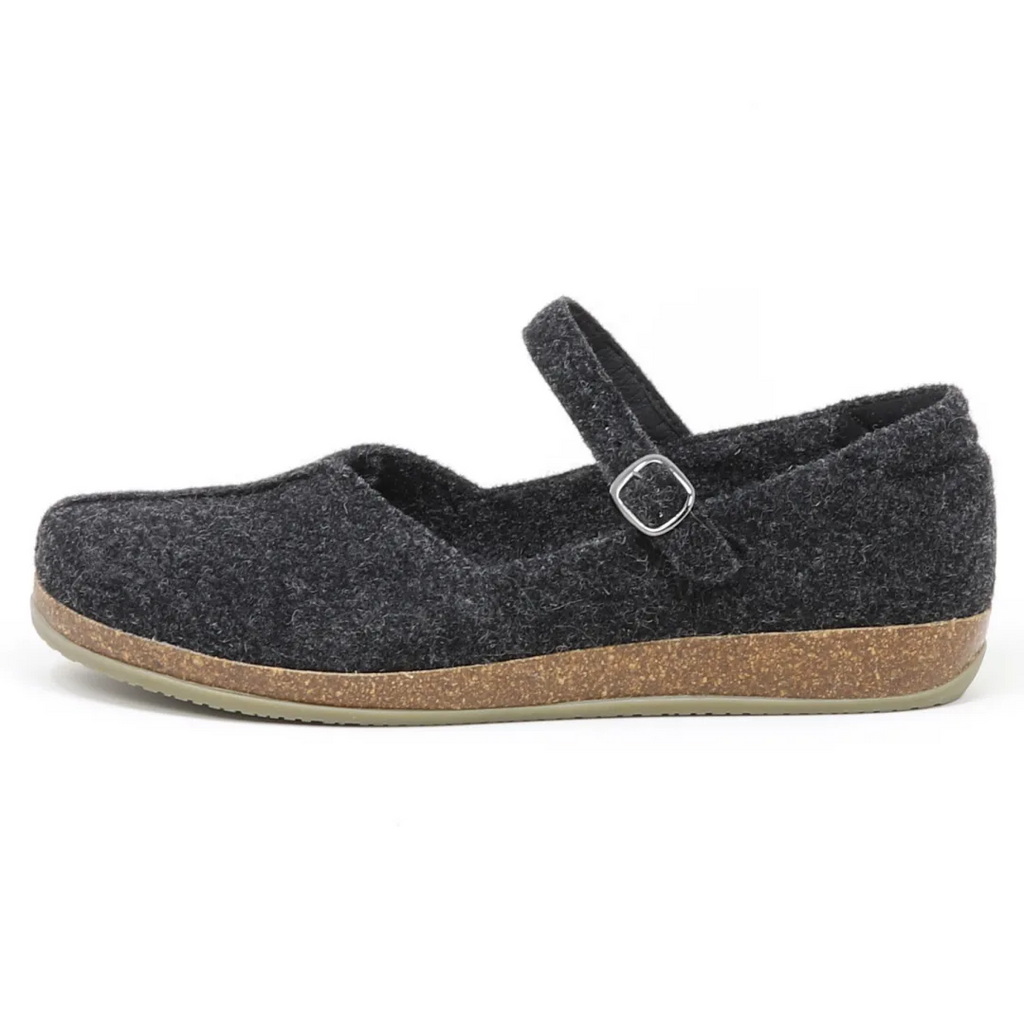 The Women's Eva Wool Mary-Jane is a dark gray felt shoe with a wide toe box, flat cork sole, and an adjustable buckle strap across the top.