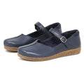 Women's Eva Leather Mary-Jane shoes in navy blue feature a cork sole, adjustable buckle strap, and a rounded toe for a timeless look.