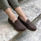 Dark brown nubuck Women’s Victoria Loafer with a cushioned insole worn with olive green pants on stone steps.