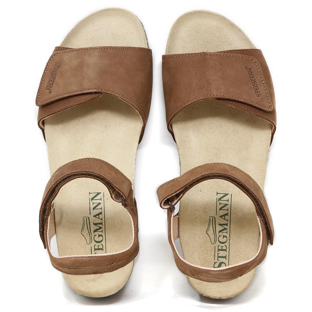 Women's Freya Leather Wedge Sandal: Brown leather sandals with adjustable straps and a flat beige sole, featuring the Stegmann logo on the insole. They offer excellent arch support and include a recycled rubber traction outsole for added stability.