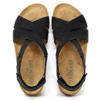 The Women's Hannah Leather Sandal - Medium features a black strappy design with cork soles, a Stegmann logo on the insoles, and a cushioned suede footbed for added comfort. It offers superior arch support, ideal for all-day wear.