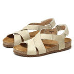 The Women's Hannah Leather Sandal - Medium showcases a beige open-toe design with cork soles, wide straps, and a cushioned suede footbed for added comfort.