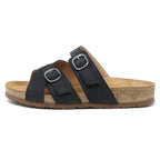The Women's Heidi Leather Sandal features adjustable black straps with buckle closures, a sustainable cork midsole, and a rubber sole for comfort.