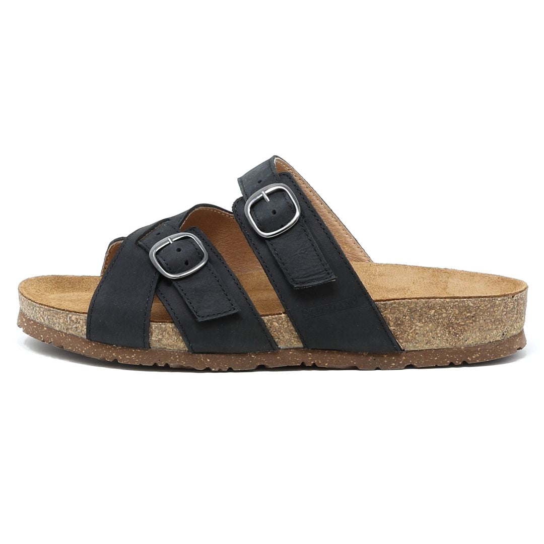 The Women's Heidi Leather Sandal features adjustable black straps with buckle closures, a sustainable cork midsole, and a rubber sole for comfort.