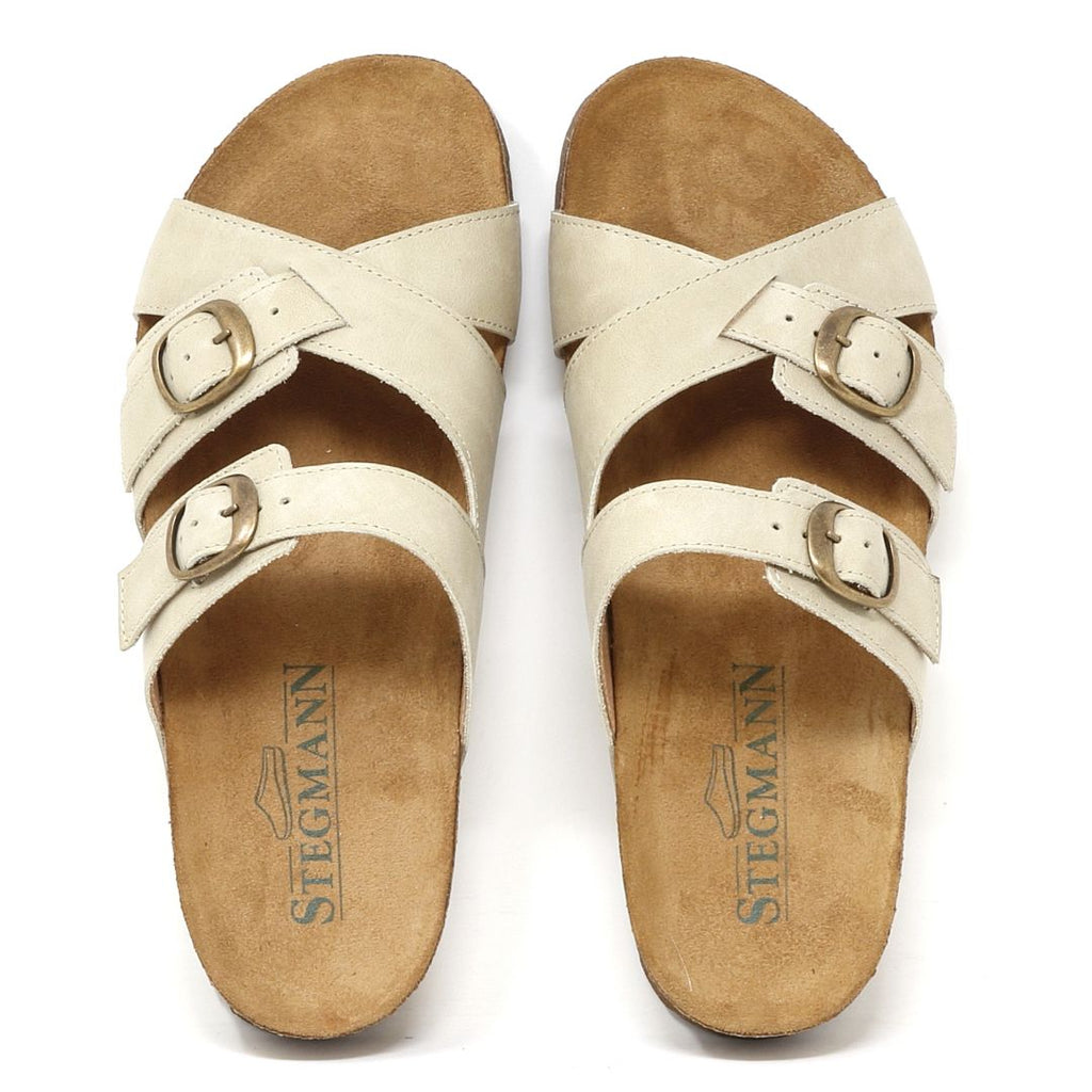 The Women's Heidi Leather Sandal in beige features two adjustable buckle straps per foot, the Stegmann logo on the insole, and an ultra-cushy footbed for exceptional comfort.