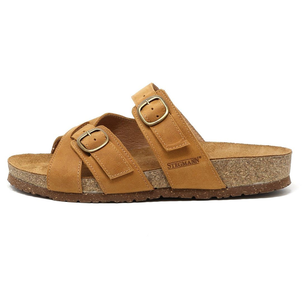 The Women's Heidi Leather Sandal - Medium features a tan leather design with an ultra-cushy footbed, two adjustable straps, a sustainable cork midsole, and the Stegmann logo on the side.