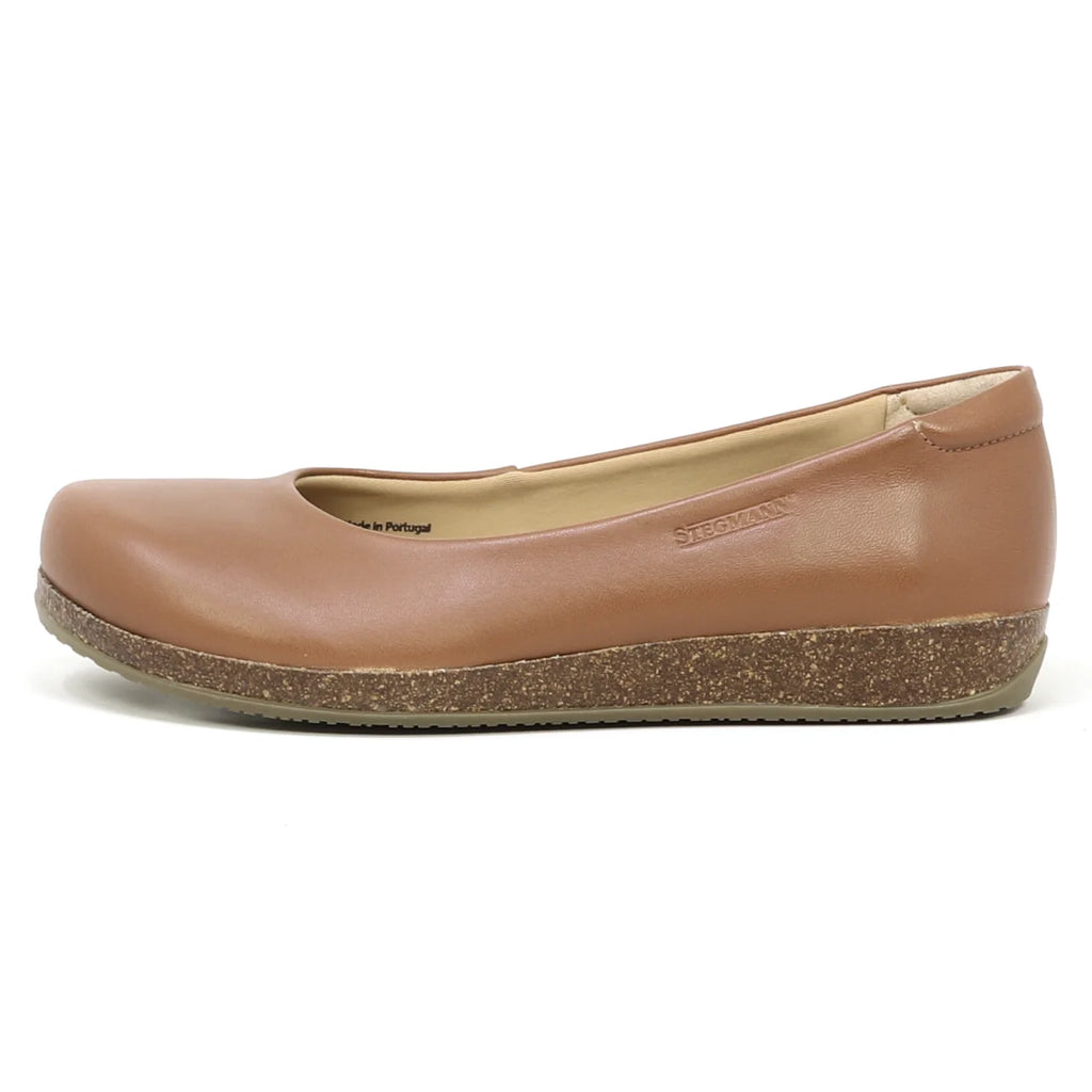 The Women's Helene Ballet Flat is shown in side profile with a single brown leather design, rounded toe, and cork-textured sole for a comfortable fit.