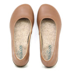 The Women’s Helene Ballet Flat is a tan, round-toe shoe featuring felt insoles for comfort. The insoles display the Stegmann brand name when viewed from above.