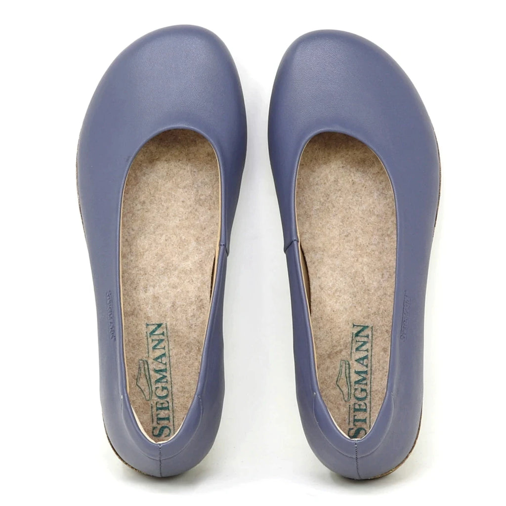 A pair of Women's Helene Stretch Leather Ballet Flats in purple, shown from the top with rounded toes and beige insoles featuring Stegmann branding—bunion friendly design for extra comfort.