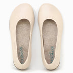 The Women's Helene Stretch Leather Ballet Flat is a beige, round-toe slip-on with felt insoles, designed for bunion-friendly comfort and "Stegmann" branding inside.