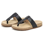 A pair of Women's Inga Leather Sandals in black, featuring arch support and a contoured cork footbed, placed side by side on a white background.