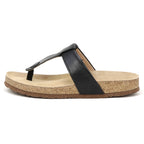 The Women's Inga Leather Sandal features a single black leather thong strap, a contoured cork footbed for arch support, and a flat brown sole, shown from the side.