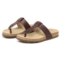 A pair of Women's Inga Leather Sandals featuring brown leather straps and contoured beige cork footbeds, positioned side by side facing left.