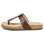 The Women's Inga Leather Sandal features brown leather straps, a contoured cork footbed, and a beige insole, shown side view on a white background. Enjoy stylish arch support and comfort for everyday wear.