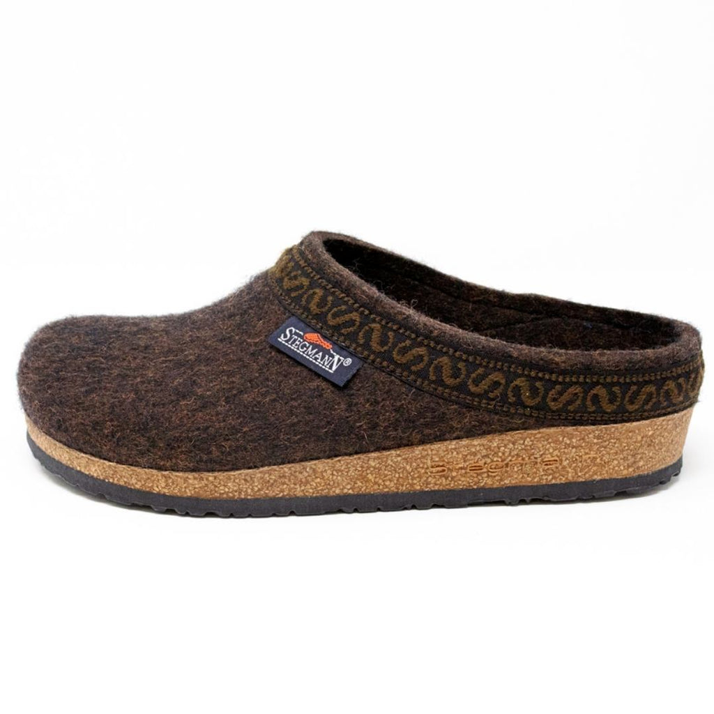 The Women's Original 108 Wool Clog - Medium is a brown Merino wool felt slipper with a cork sole, patterned trim, and Stegmann label on the side, displayed on a white background.
