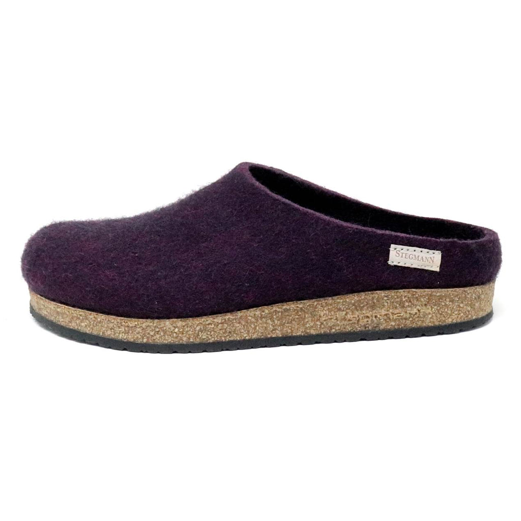 The Women's Essenz Wool Clog is crafted from dark purple Merino wool and features a cork/latex footbed with a black rubber bottom.